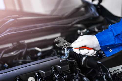 Closeup,concept,of,a,car,mechanic,holding,a,wrench,checking